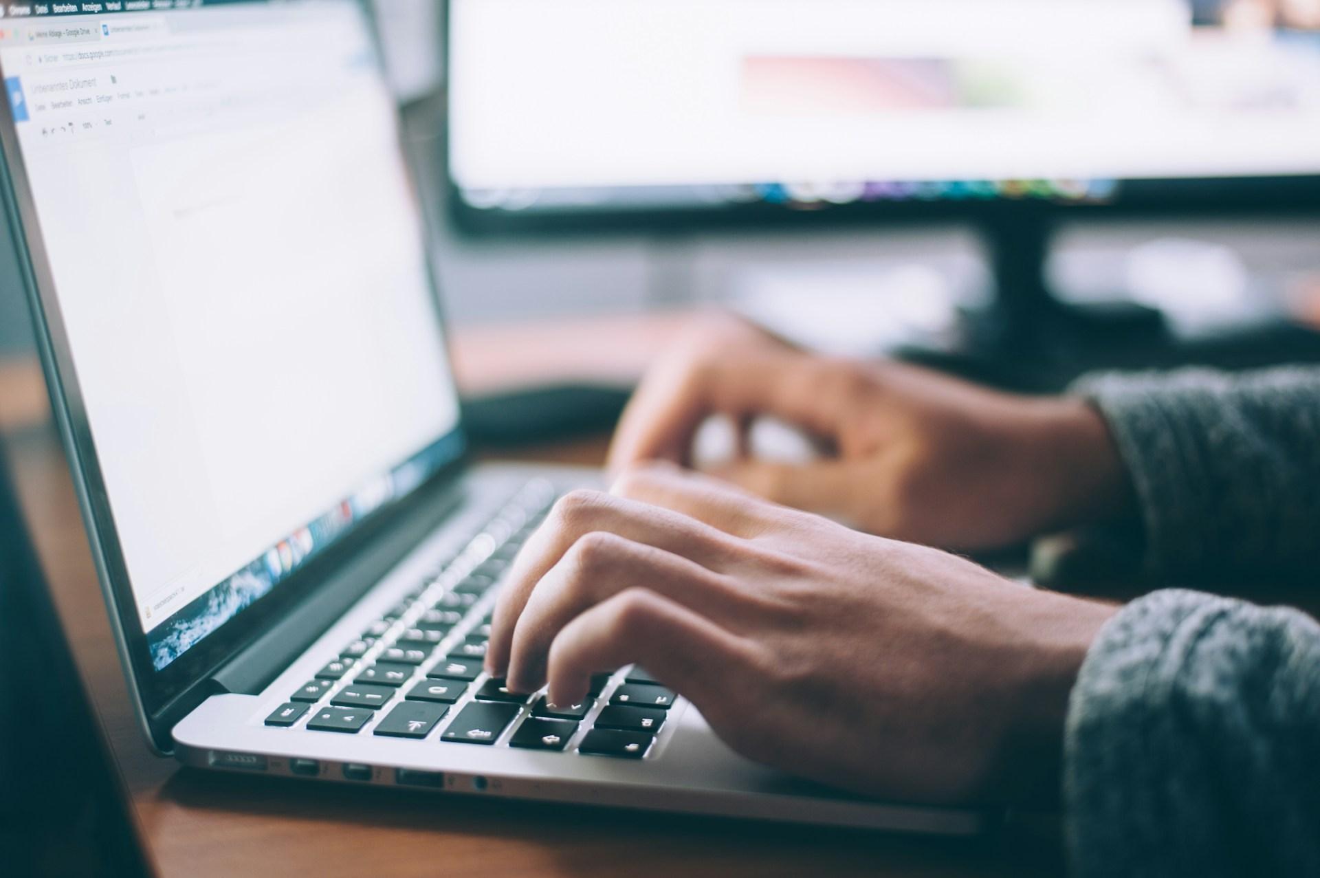 Person using a MacBook for everyday software tasks
